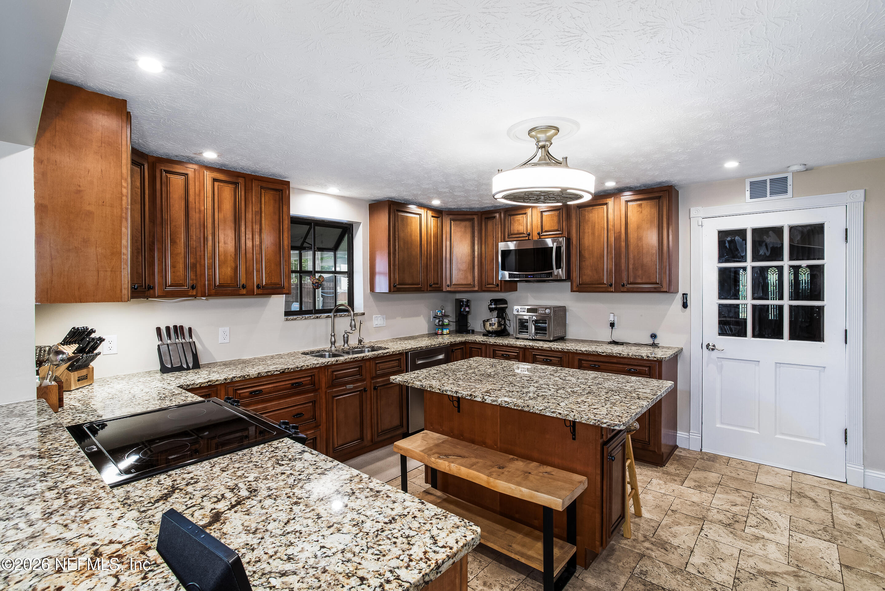 11401 Old Plank Road Jacksonville, FL 32220 - Photo 19 of 42 a kitchen with a stove a sink and a refrigerator