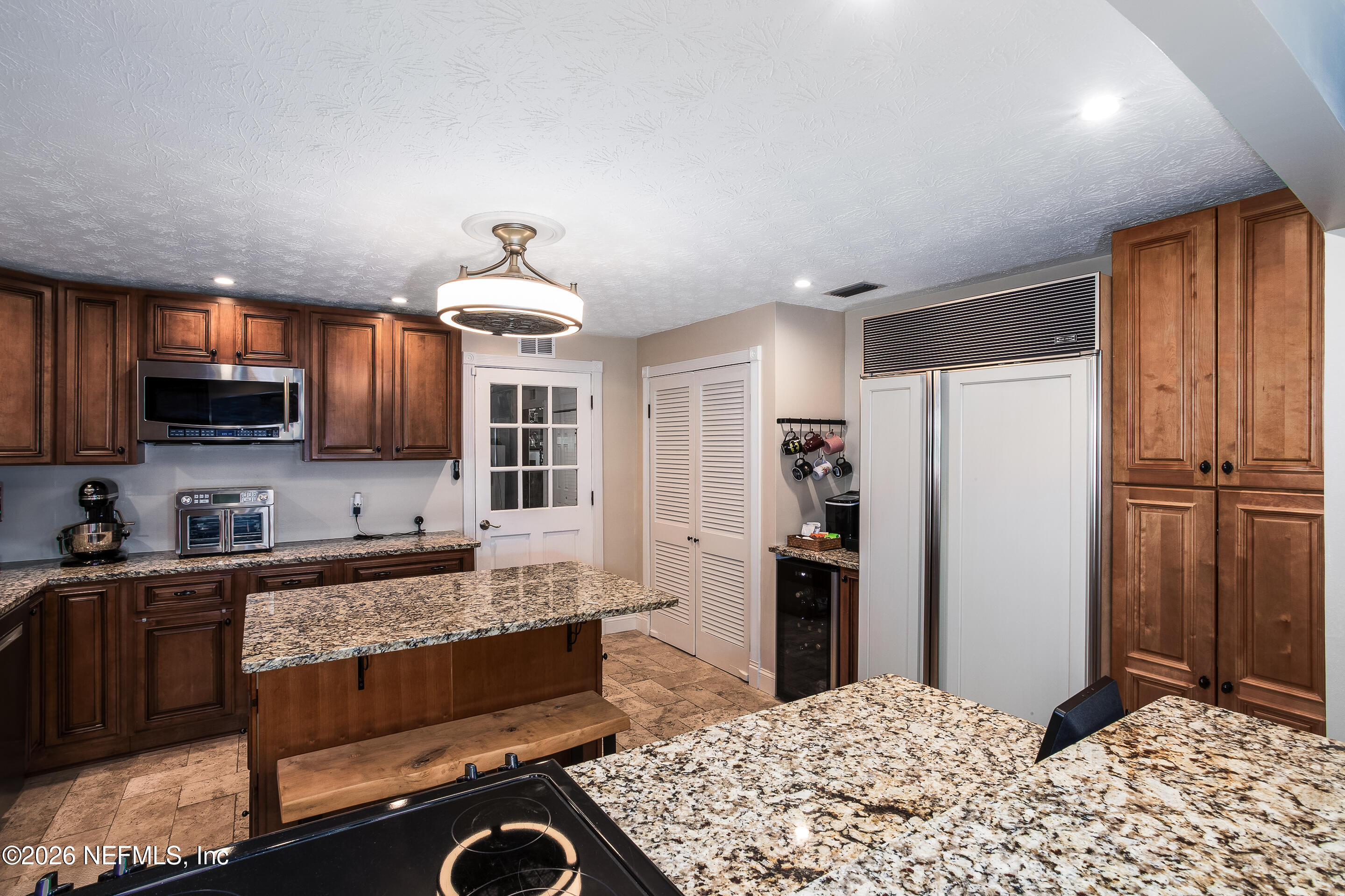 11401 Old Plank Road Jacksonville, FL 32220 - Photo 20 of 42 a kitchen with stainless steel appliances kitchen island granite countertop a refrigerator and a stove top oven