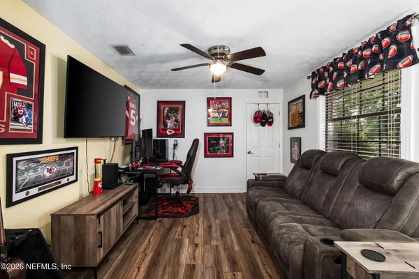 a living room with furniture and a flat screen tv