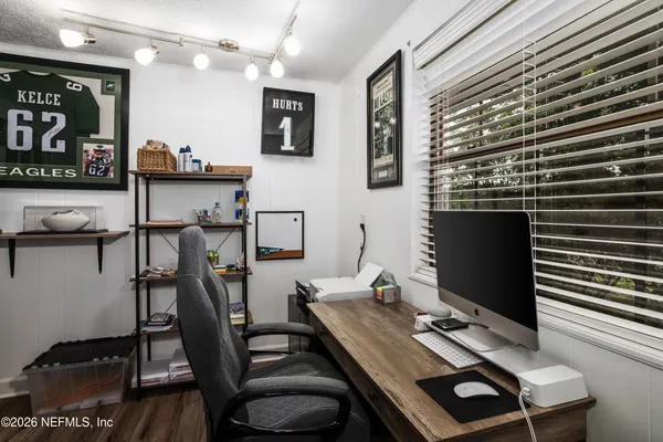 a view of a workspace with furniture and gym equipment