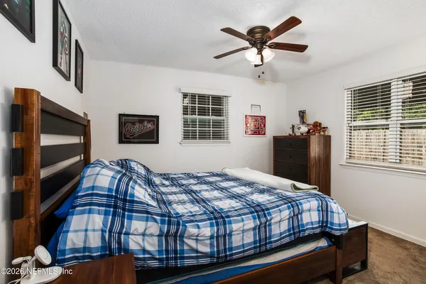 a bedroom with bed and wooden floor