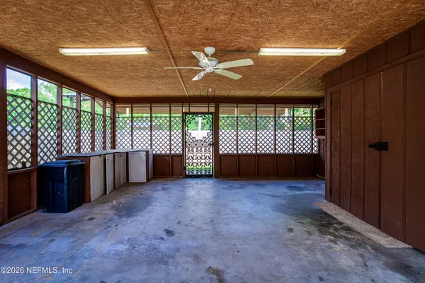 an empty room with a balcony and large window