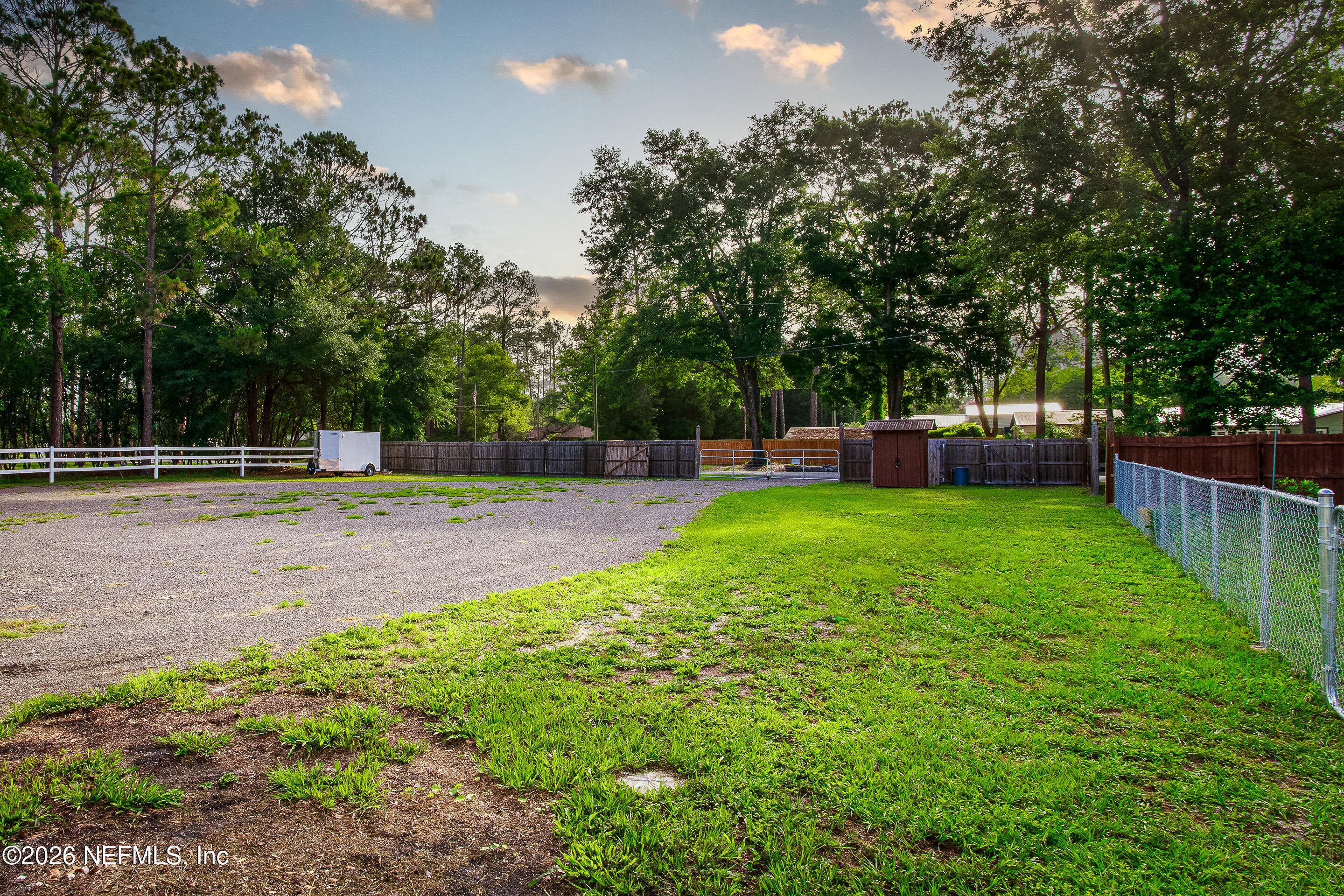 11401 Old Plank Road Jacksonville, FL 32220 - Photo 42 of 42 a view of a backyard with large trees and wooden fence