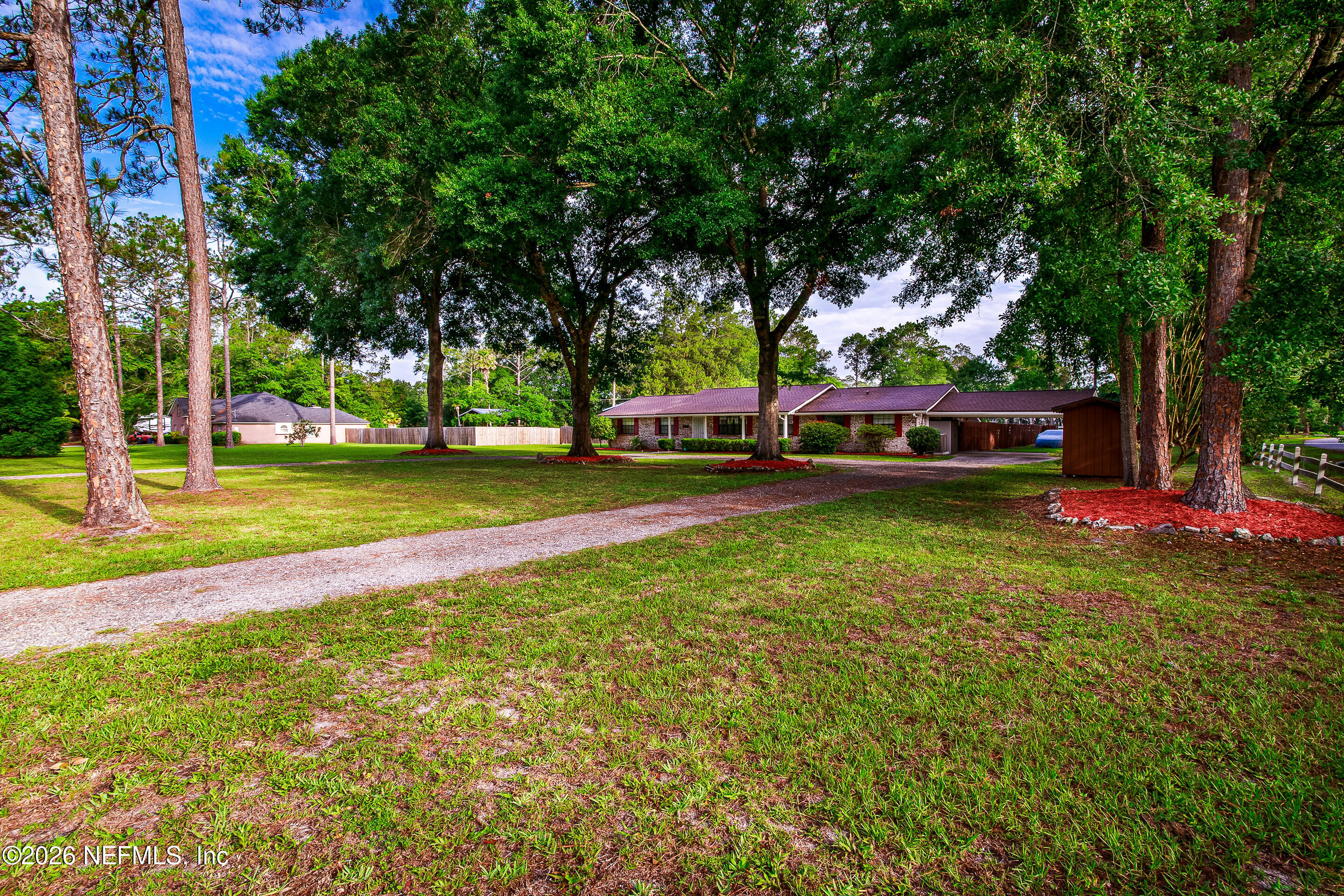 11401 Old Plank Road Jacksonville, FL 32220 - Photo 5 of 42 a view of a park with large trees and a wooden fence