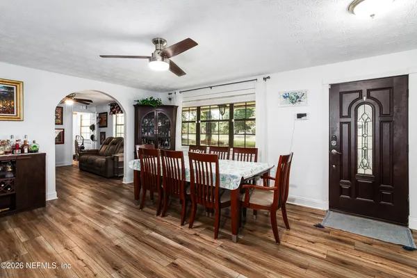 a view of a livingroom with furniture window and wooden floor
