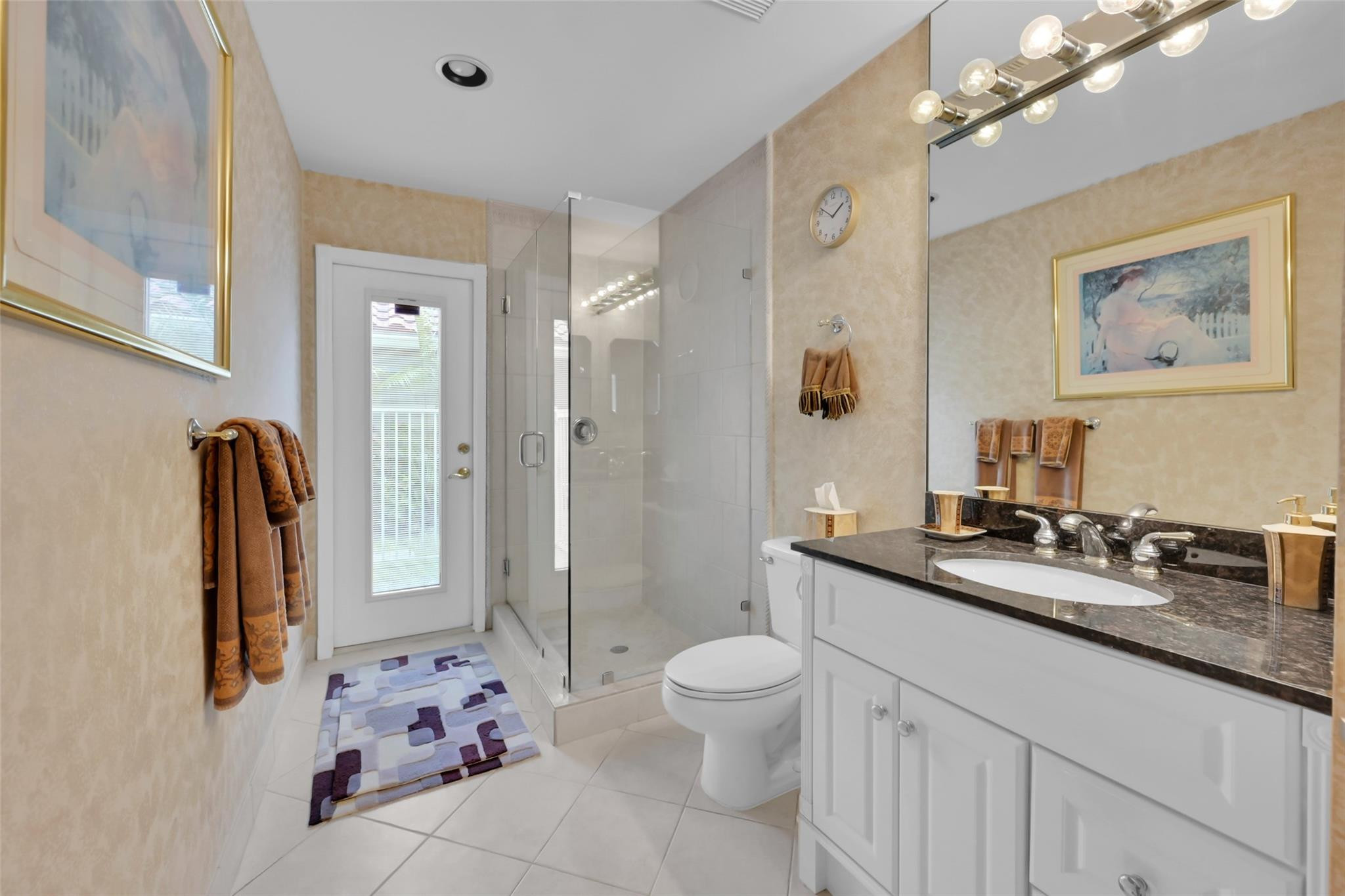 19640 Dinner Key Drive Boca Raton, FL 33498 - Photo 13 of 44 a spacious bathroom with a granite countertop sink a toilet a mirror a vanity and shower