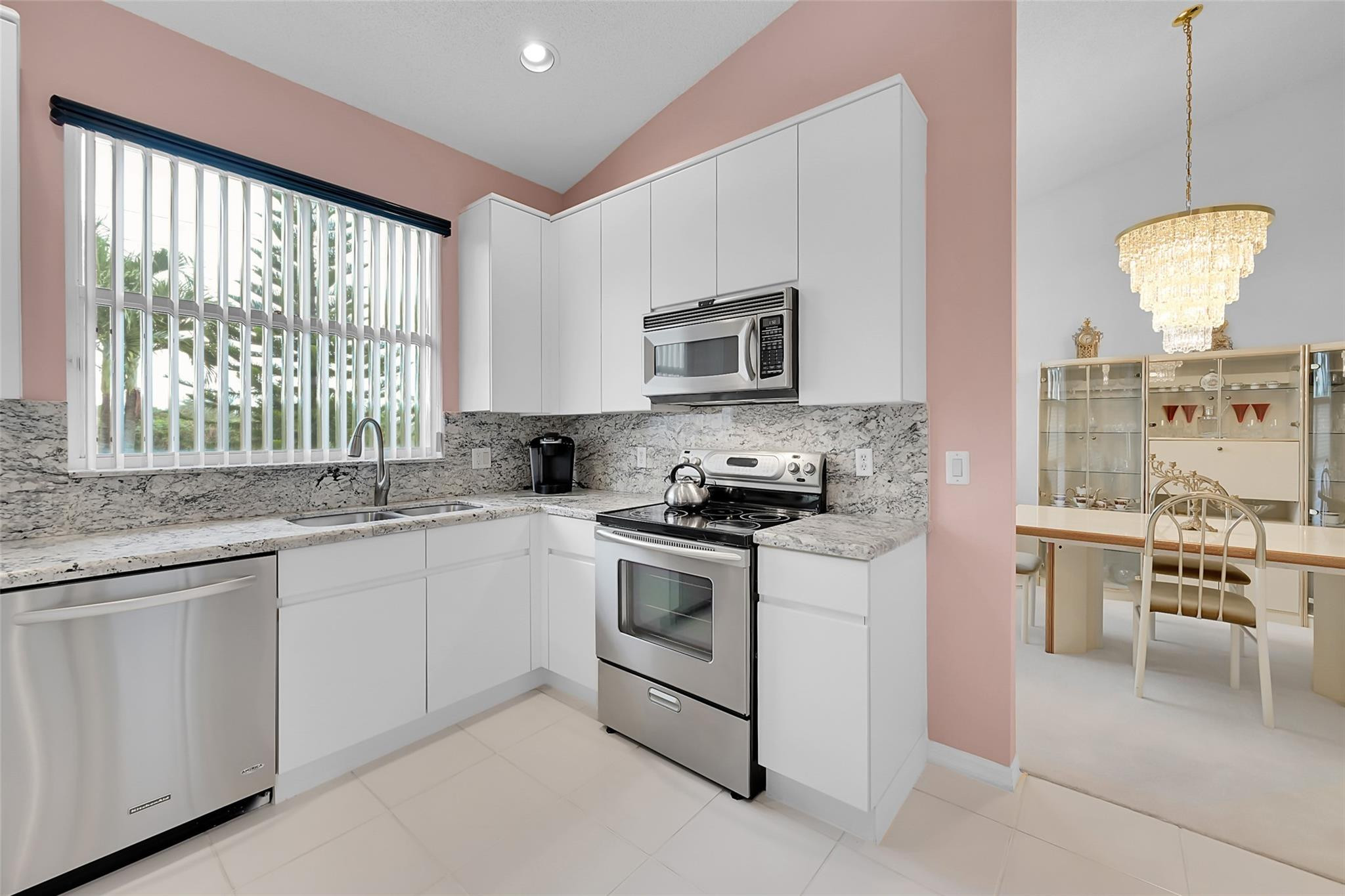 19640 Dinner Key Drive Boca Raton, FL 33498 - Photo 9 of 44 a kitchen with cabinets appliances and a large window