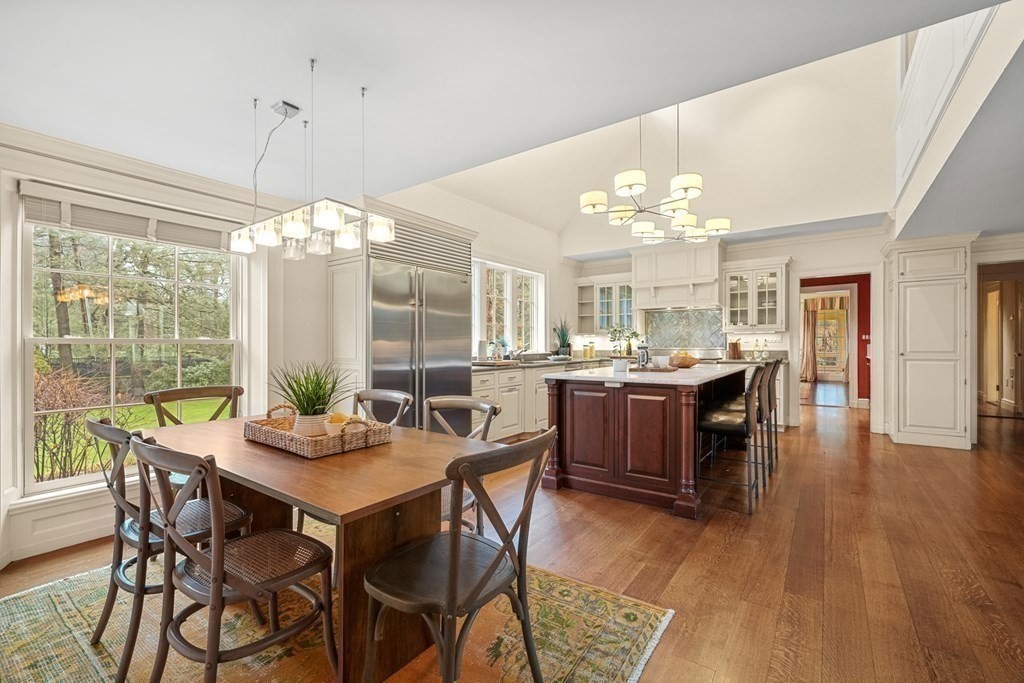 20 Sears Road Brookline, MA 02445 - Photo 13 of 40 a view of a dining room and livingroom with furniture wooden floor a chandelier