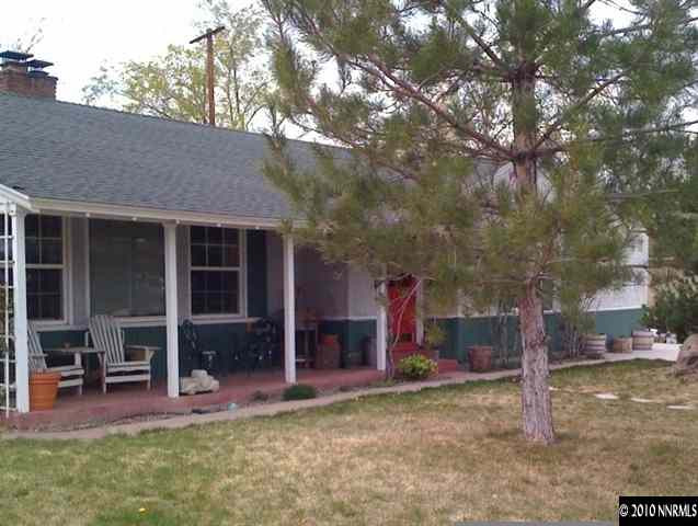 665 Arbutus Street Reno, NV 89509 - Photo 1 of 9 a view of a house with a yard and tree s