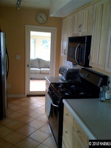 665 Arbutus Street Reno, NV 89509 - Photo 4 of 9 a kitchen with a stove and a refrigerator