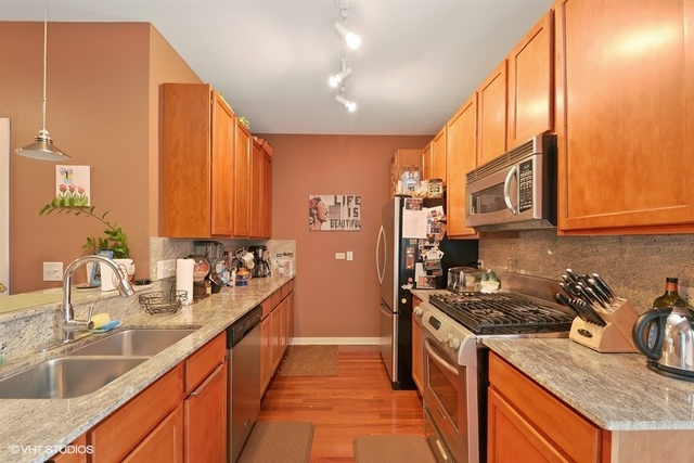 1244 West Monroe Street, Unit 7 Chicago, IL 60607 - Photo 4 of 12 a kitchen with a sink stove top oven and cabinets