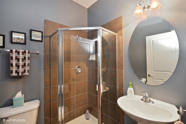 1244 West Monroe Street, Unit 7 Chicago, IL 60607 - Photo 10 of 12 a bathroom with a sink toilet and shower