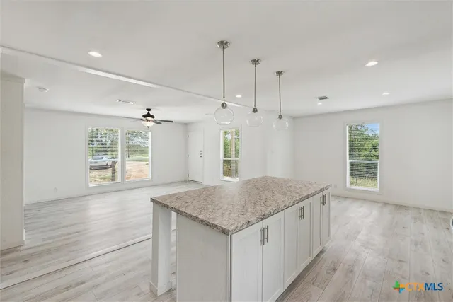 a kitchen with a wooden floor and window