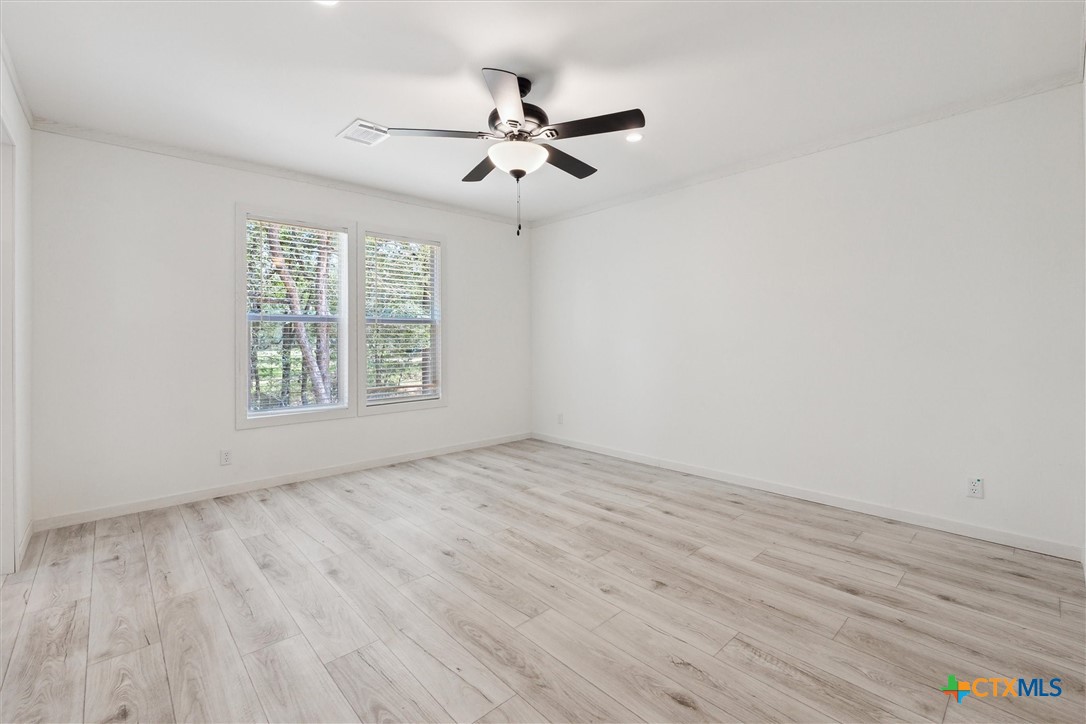 855 Roosevelt Road Luling, TX 78648 - Photo 17 of 47 wooden floor in an empty room with a window