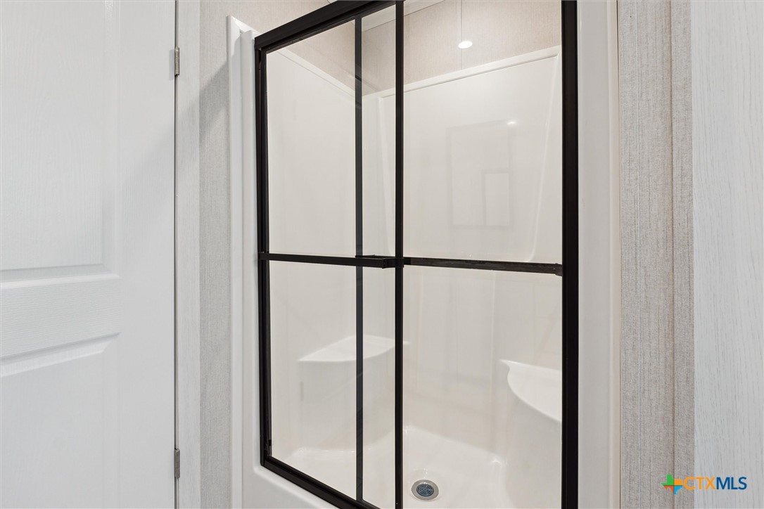 855 Roosevelt Road Luling, TX 78648 - Photo 22 of 47 a bathroom with a glass shower door