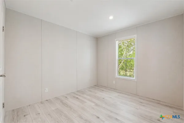 an aerial view of residential houses with outdoor space and trees