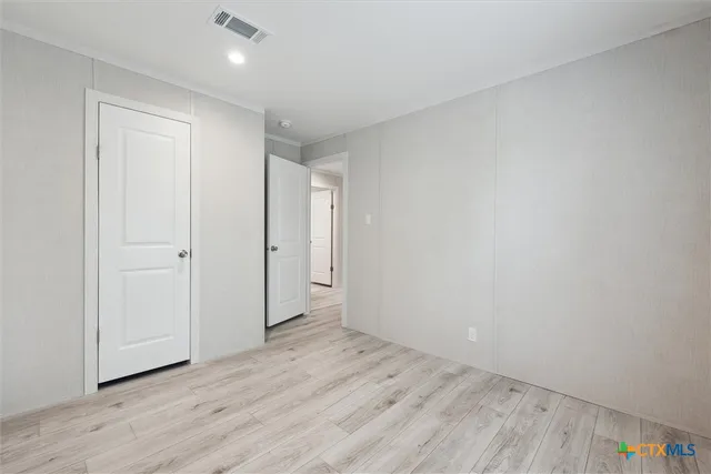 a view of an empty room and wooden floor