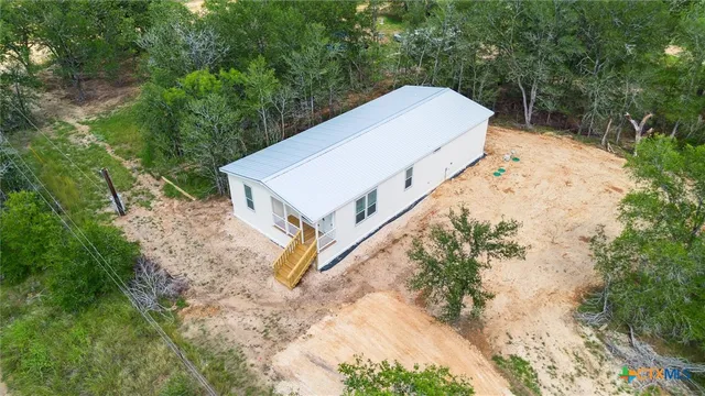a view of a small house with a yard
