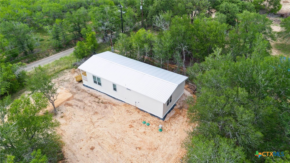 855 Roosevelt Road Luling, TX 78648 - Photo 39 of 47 a view of a small house with a yard and a wooden fence