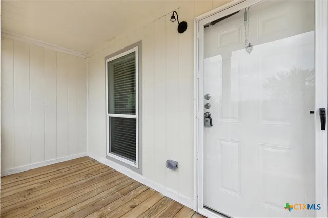 a view of a livingroom with wooden floor and cabinet