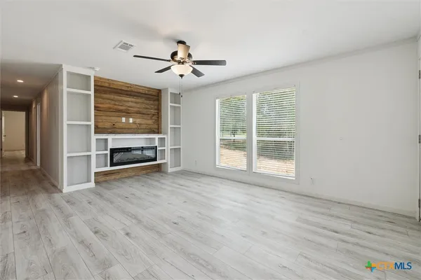a kitchen with a sink refrigerator and microwave