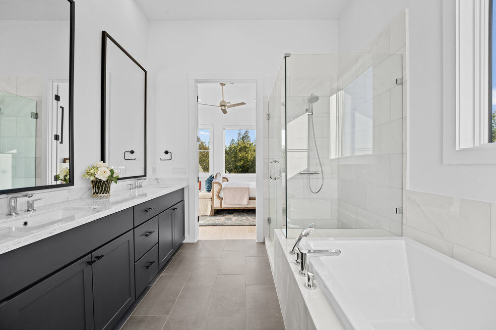 5001 Childers Path Austin, TX 78741 - Photo 23 of 40 Ensuite bathroom featuring a bath, double vanity, a stall shower, tile patterned floors, and a ceiling fan
