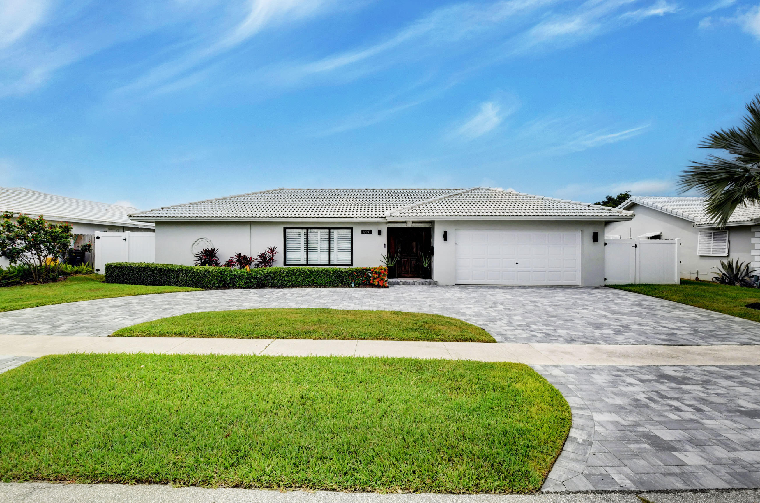1270 Southwest 13th Drive Boca Raton, FL 33486 - Photo 1 of 23 a front view of a house with a yard