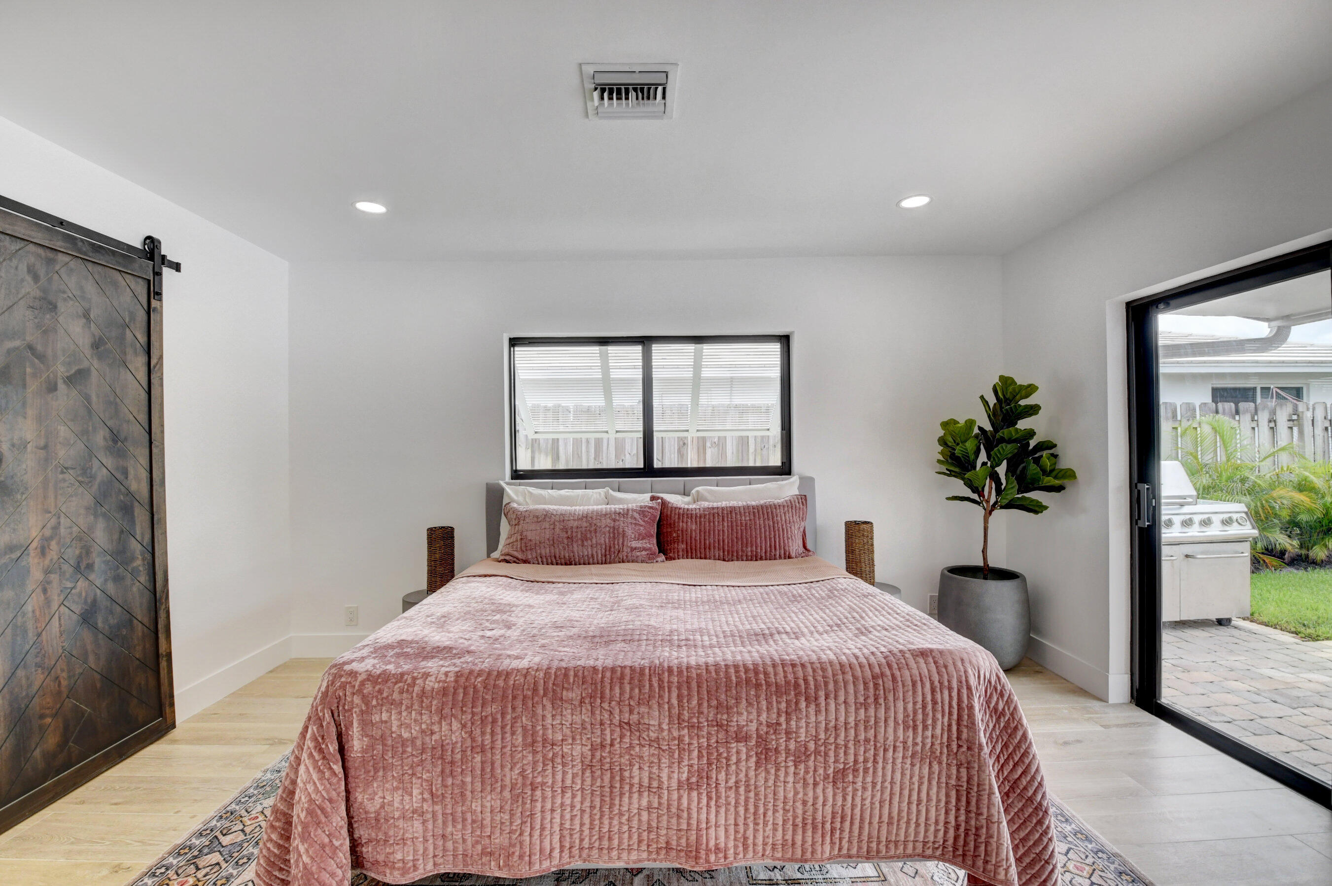 1270 Southwest 13th Drive Boca Raton, FL 33486 - Photo 15 of 23 a bedroom with a large bed and a potted plant
