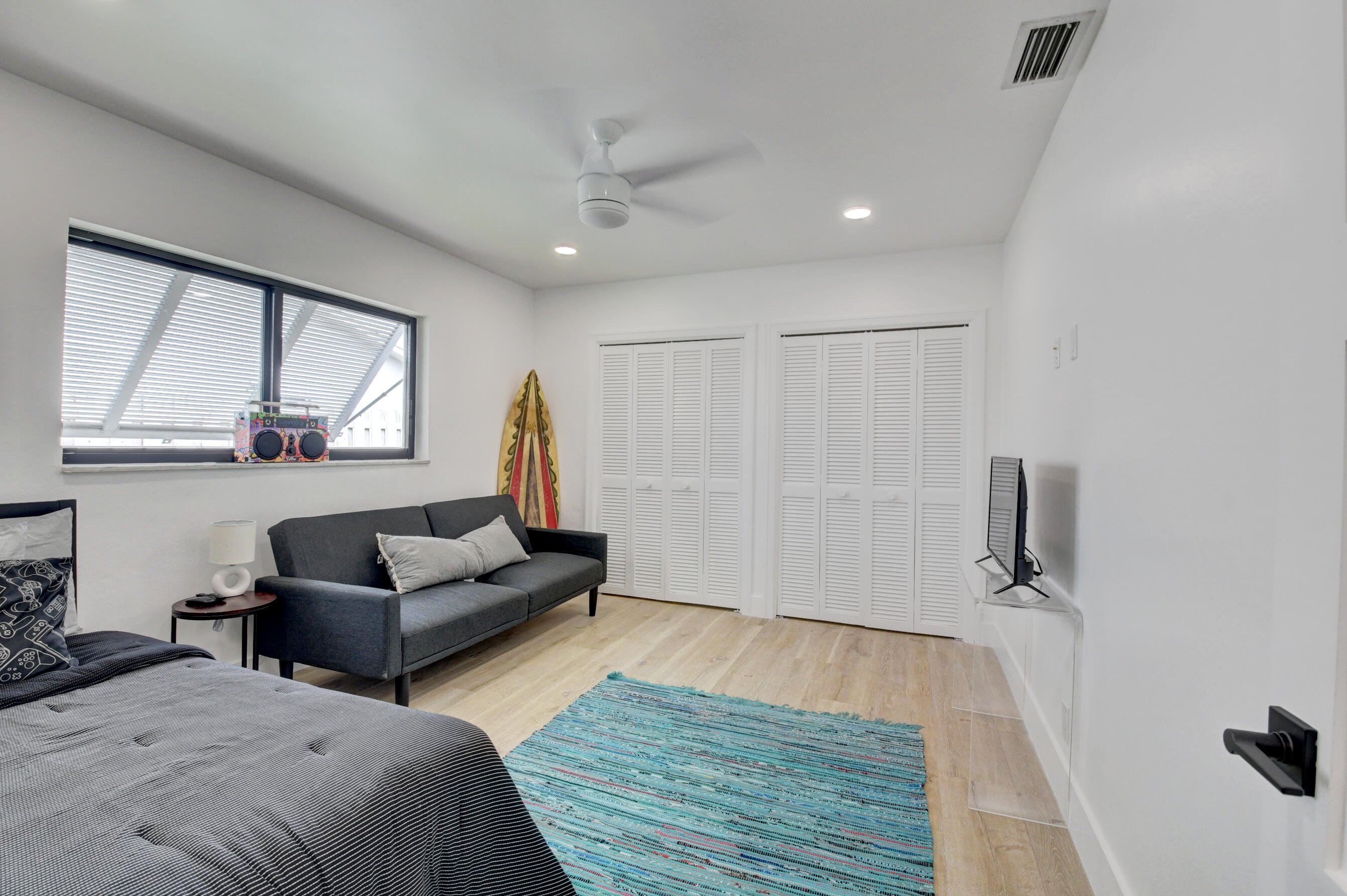 1270 Southwest 13th Drive Boca Raton, FL 33486 - Photo 20 of 23 a bedroom with furniture and a wooden floor