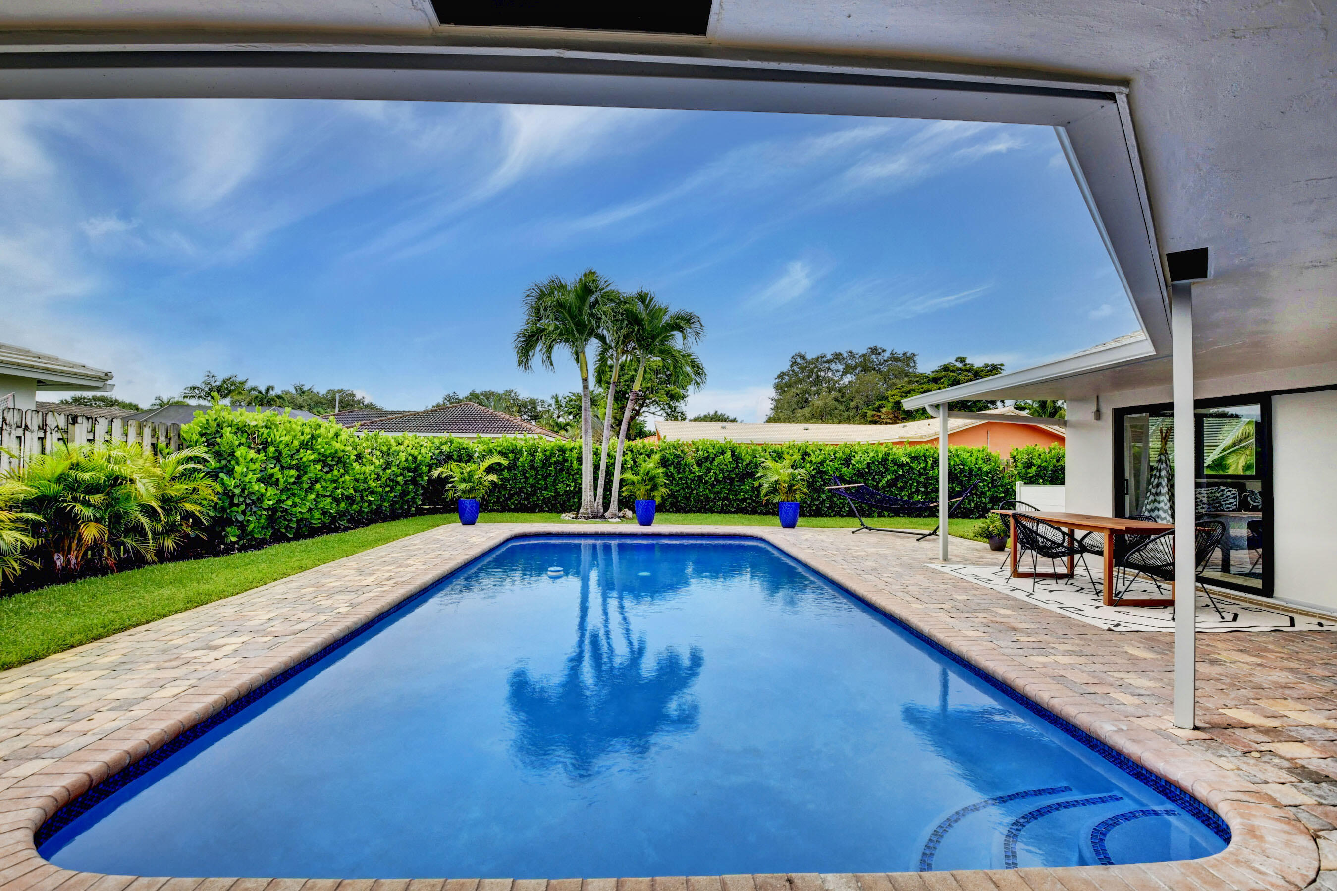 1270 Southwest 13th Drive Boca Raton, FL 33486 - Photo 3 of 23 a swimming pool with outdoor seating and yard
