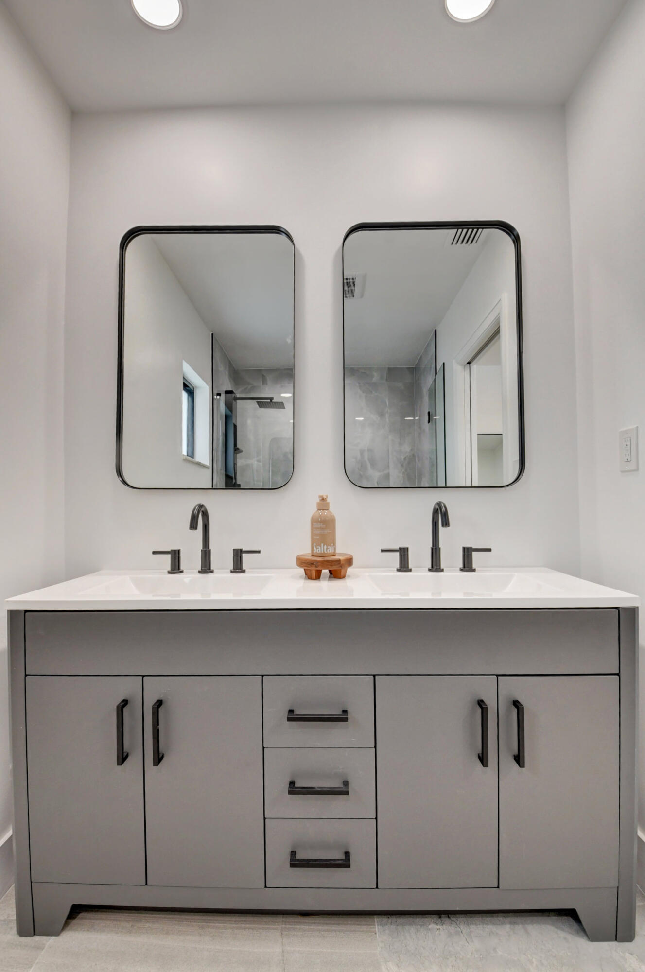 1270 Southwest 13th Drive Boca Raton, FL 33486 - Photo 8 of 23 a bathroom with double vanity sinks and a mirror