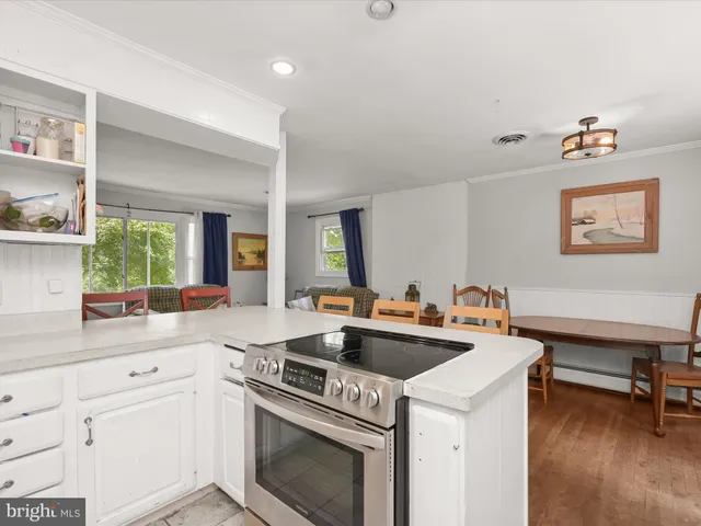 a kitchen with appliances a sink and cabinets