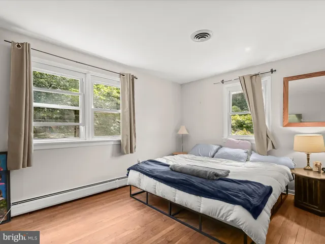 a kitchen that has a sink a stove and a wooden floor