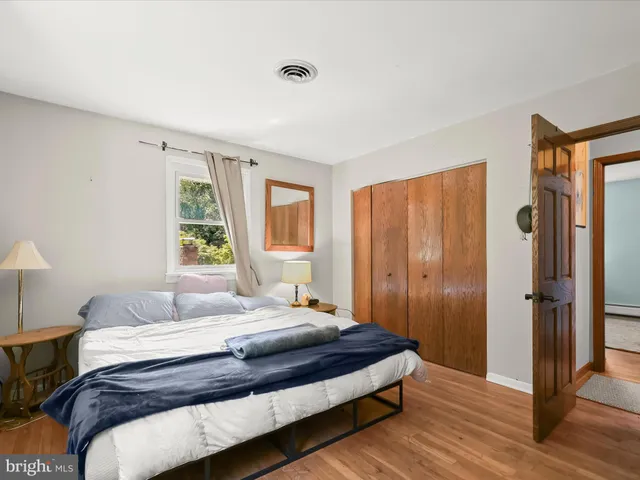 a bedroom with a bed and a window