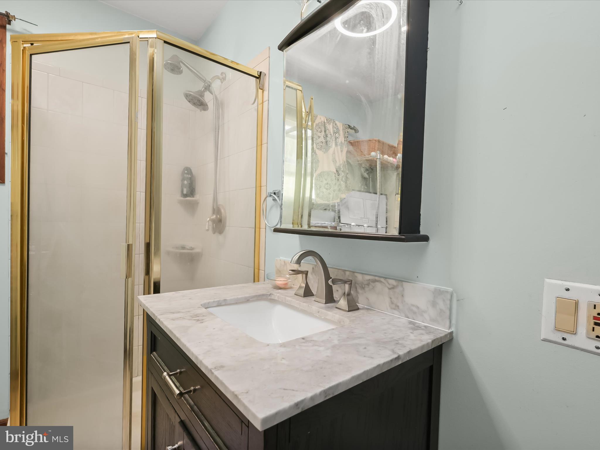 17515 Masemore Road Parkton, MD 21120 - Photo 21 of 36 a bathroom with a granite countertop sink and a mirror