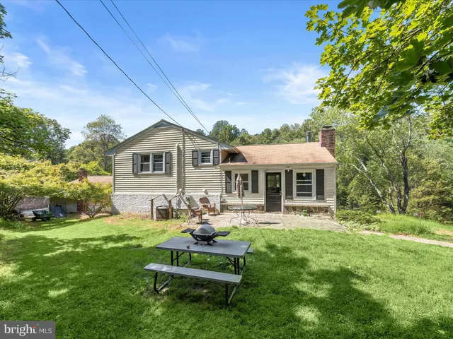a front view of a house with swimming pool having outdoor seating