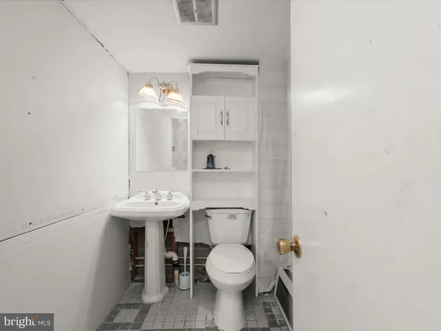 a bathroom with a sink a toilet and mirror