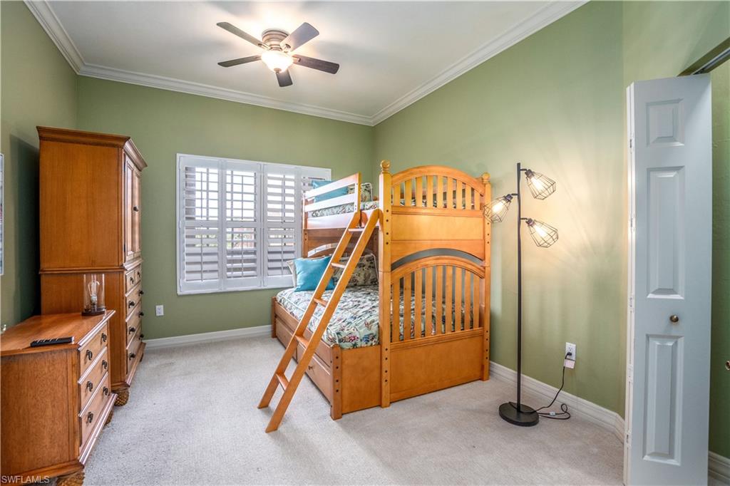 450 Bayfront Place, Unit 4508 Naples, FL 34102 - Photo 11 of 24 a bedroom with a bed and a chandelier