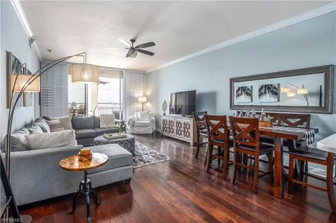 a living room with furniture a table and a large window