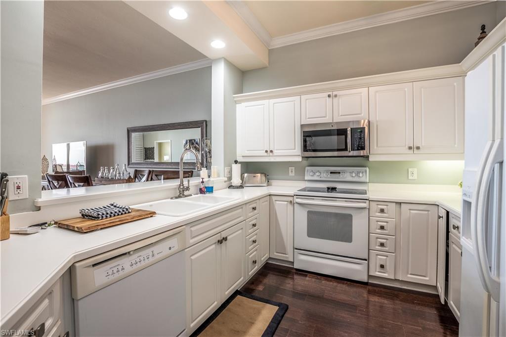 450 Bayfront Place, Unit 4508 Naples, FL 34102 - Photo 5 of 24 a kitchen with white cabinets and appliances
