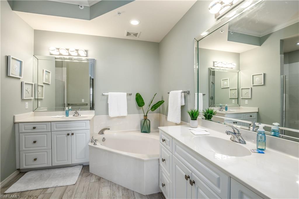 450 Bayfront Place, Unit 4508 Naples, FL 34102 - Photo 9 of 24 a bathroom with a double vanity sink mirror and bathtub
