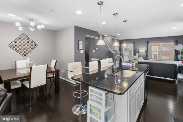 a kitchen with a table chairs and couches