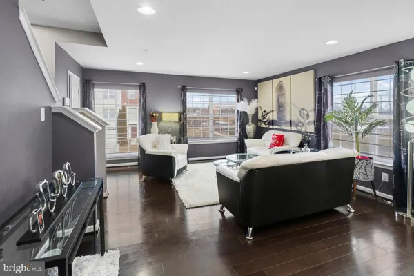 a living room with furniture and wooden floor