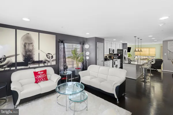 a living room with furniture and a large window with wooden floor