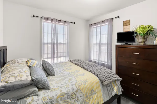 a bedroom with a bed and a television