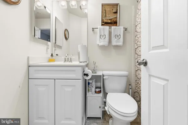 a white toilet sitting next to a bathroom sink