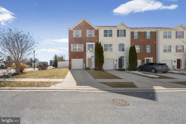 a view of residential houses with a street
