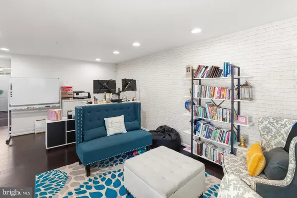 a living room with furniture and book shelf
