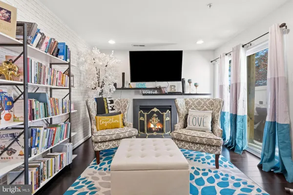a living room with furniture fireplace and flat screen tv
