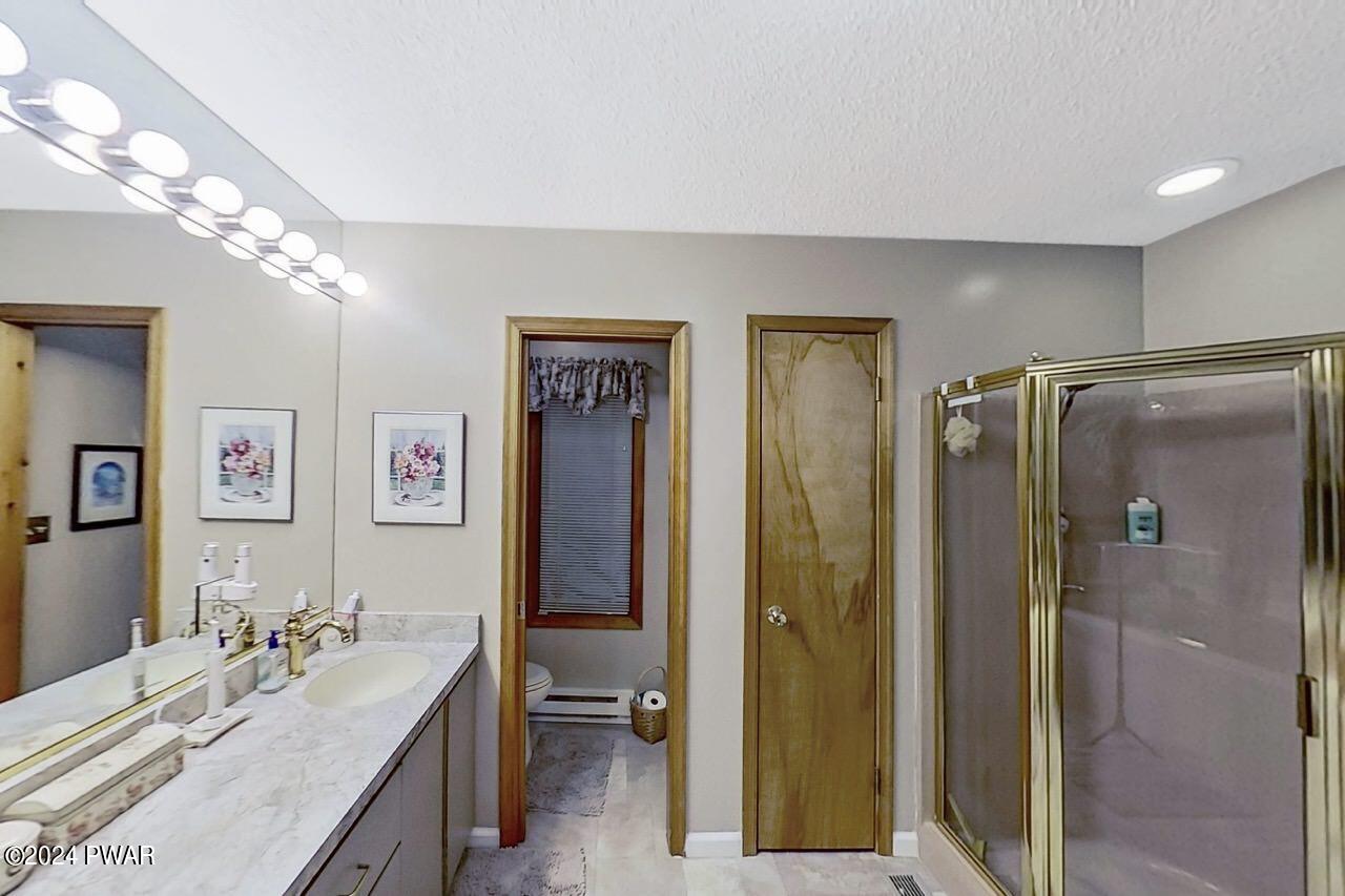 141 Maple Ridge Drive Hawley, PA 18428 - Photo 56 of 84 a bathroom with a double vanity sink mirror and shower